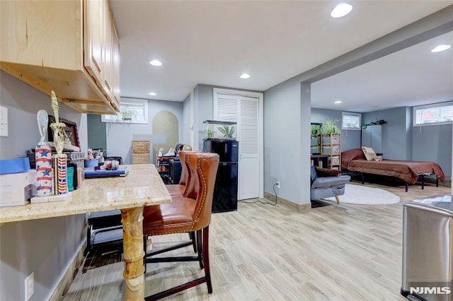 dining space featuring baseboards, light wood-style flooring, and recessed lighting