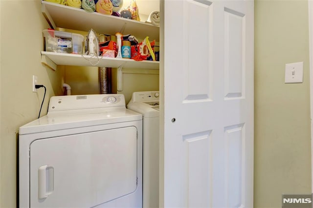 laundry room with laundry area and washing machine and clothes dryer