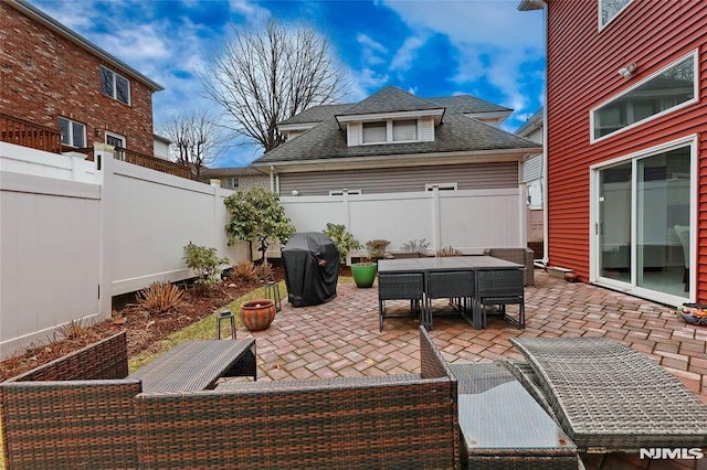 view of patio featuring a fenced backyard, outdoor dining area, and area for grilling