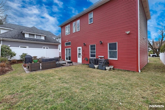 rear view of house with an outdoor hangout area, a lawn, and fence