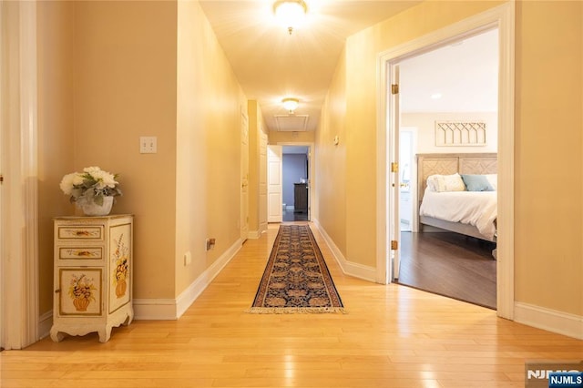 hallway with baseboards and light wood-type flooring