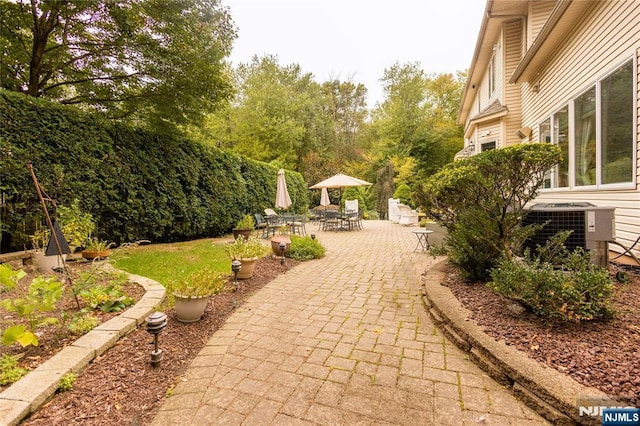 view of patio / terrace with outdoor dining space and central AC unit