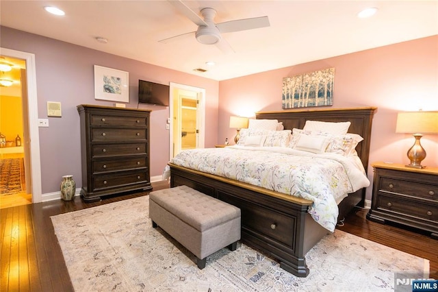 bedroom featuring a ceiling fan, hardwood / wood-style floors, recessed lighting, connected bathroom, and baseboards