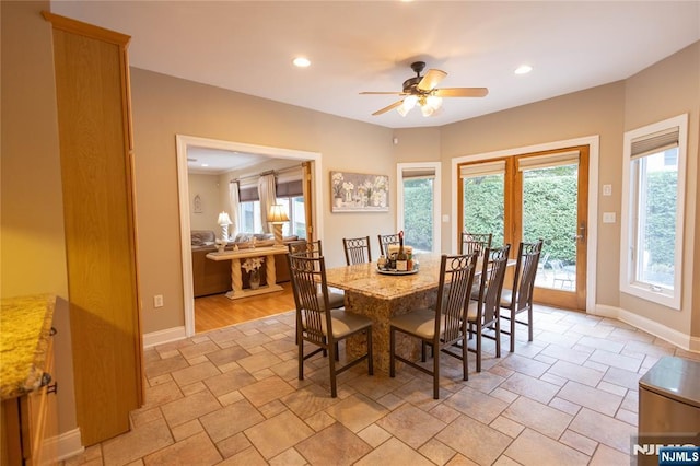 dining space with baseboards, plenty of natural light, and ceiling fan