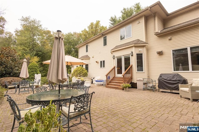 view of patio / terrace with entry steps, outdoor dining area, and grilling area