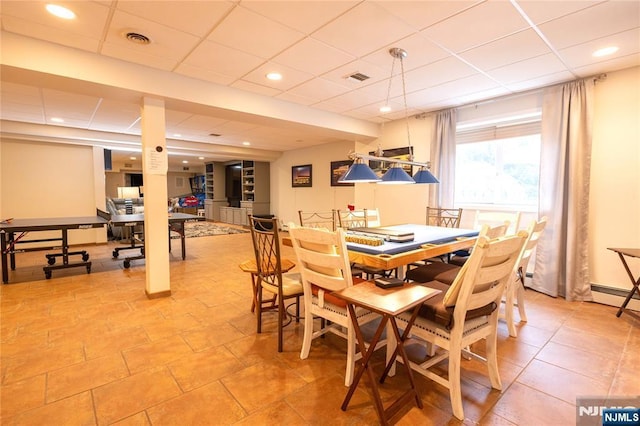 dining space featuring visible vents and a paneled ceiling