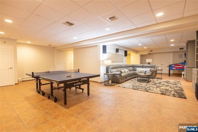 rec room with a baseboard radiator, recessed lighting, visible vents, and baseboards