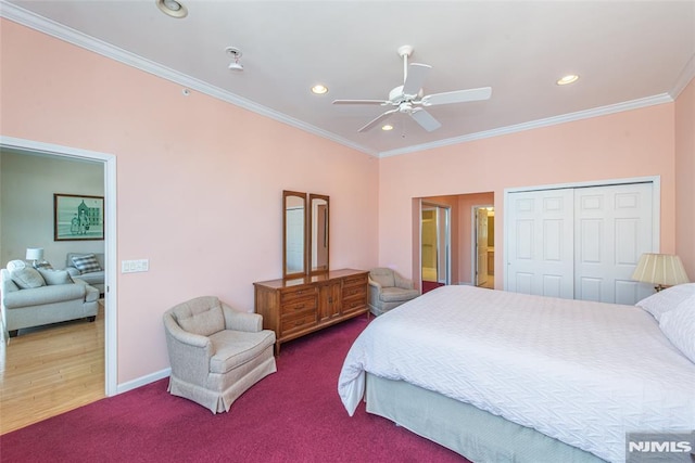 bedroom with a closet, recessed lighting, crown molding, and baseboards