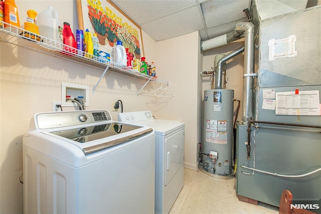 clothes washing area with heating unit, water heater, separate washer and dryer, light floors, and laundry area