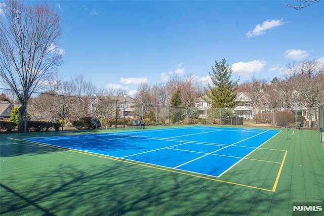 view of sport court with fence