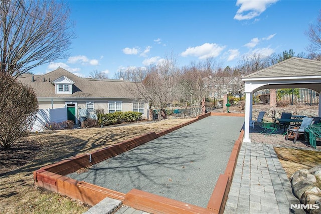 view of swimming pool featuring a gazebo and fence