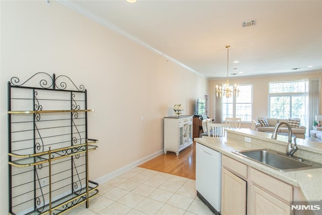 kitchen with dishwasher, ornamental molding, open floor plan, and a sink