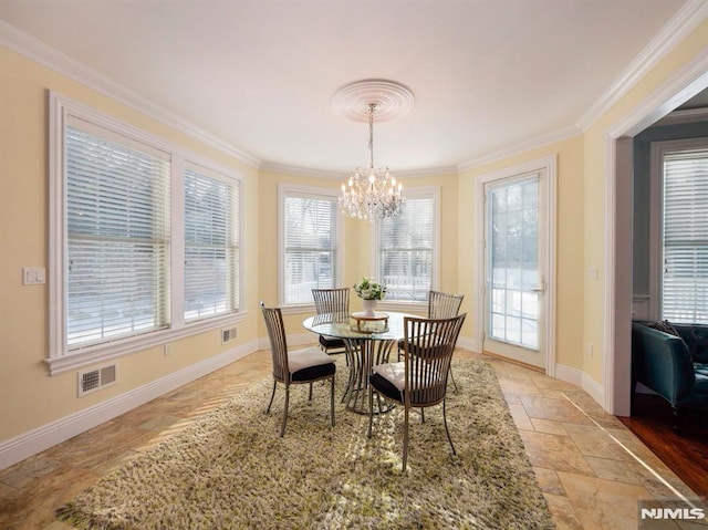 dining area with crown molding, visible vents, stone finish floor, a chandelier, and baseboards