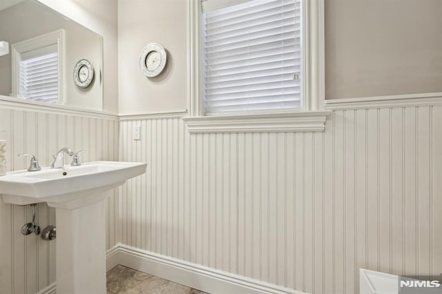 bathroom with a wainscoted wall