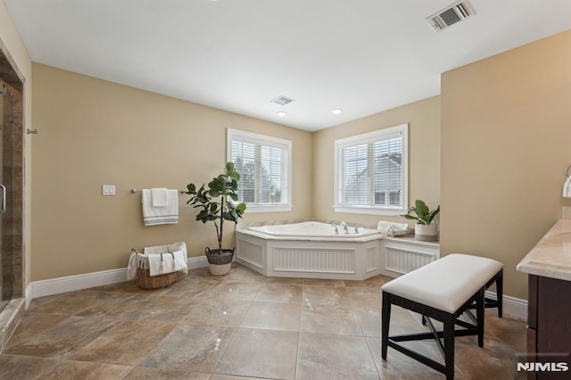 full bath with a garden tub, baseboards, visible vents, and a stall shower