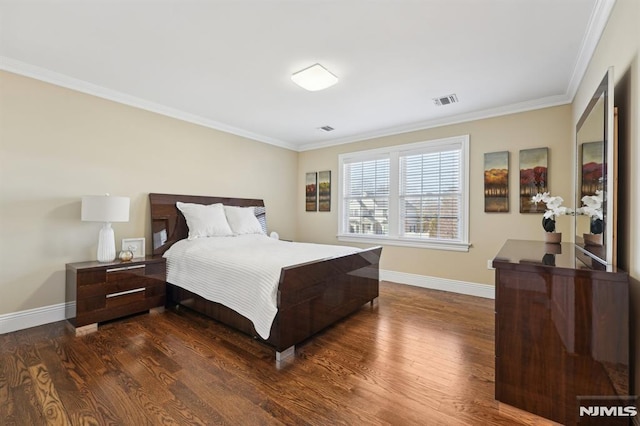 bedroom featuring dark wood-style floors, visible vents, ornamental molding, and baseboards