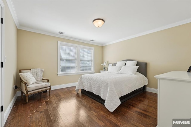 bedroom with ornamental molding, wood finished floors, visible vents, and baseboards