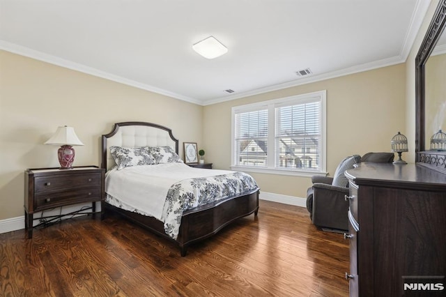 bedroom featuring baseboards, visible vents, dark wood finished floors, and ornamental molding