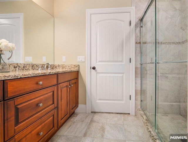 bathroom featuring a shower stall and vanity