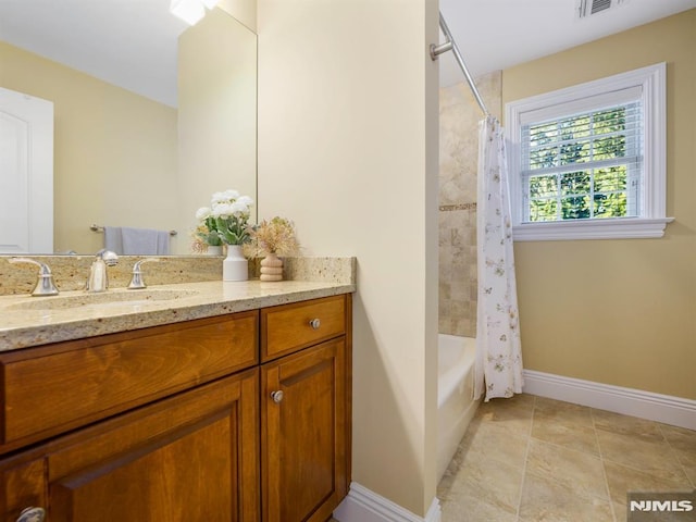 full bathroom featuring tile patterned flooring, visible vents, vanity, baseboards, and shower / bath combo with shower curtain