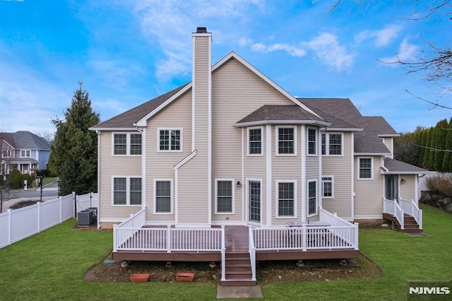 back of house with a chimney, fence, cooling unit, and a yard