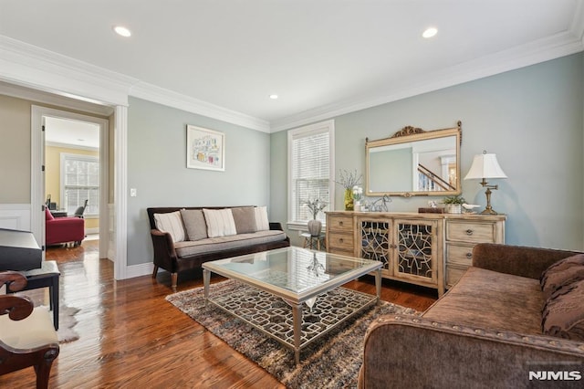 living area with plenty of natural light, ornamental molding, and wood finished floors