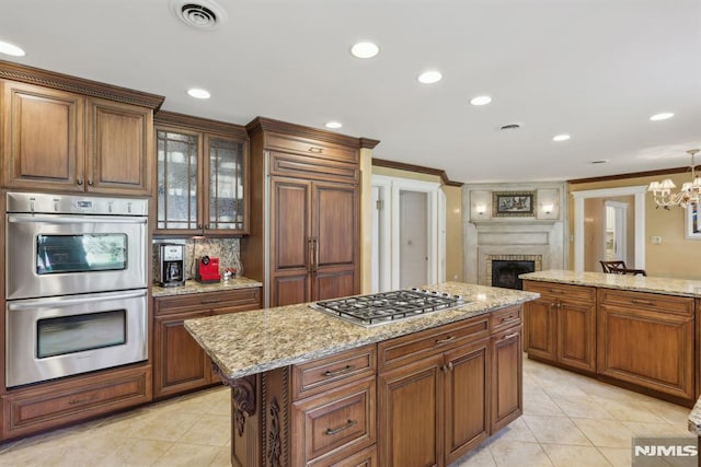 kitchen featuring appliances with stainless steel finishes, visible vents, crown molding, and light tile patterned flooring