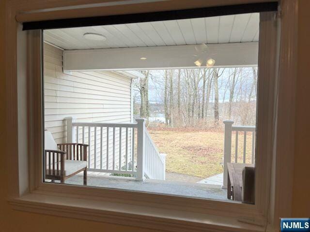 doorway to outside featuring beamed ceiling