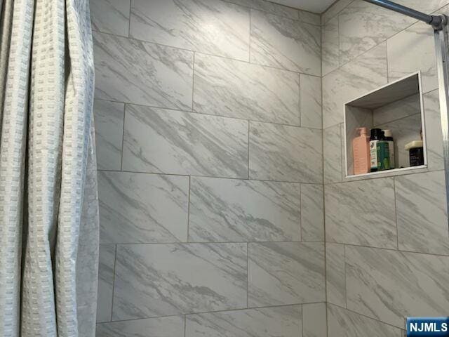 room details with a tile shower