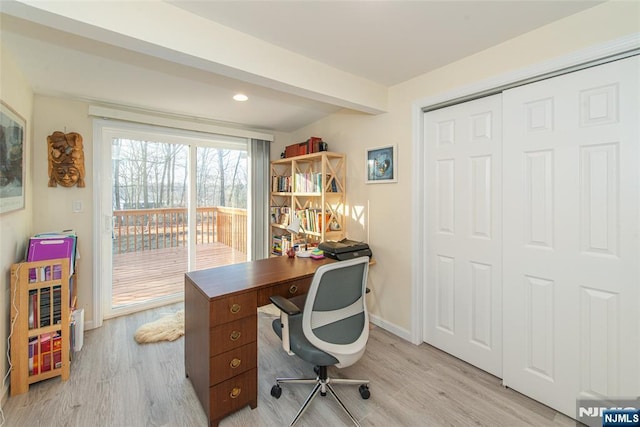 office area featuring beam ceiling, light wood-style flooring, and baseboards