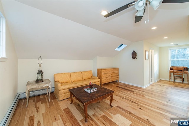 living area with light wood finished floors, a baseboard radiator, recessed lighting, lofted ceiling with skylight, and baseboards