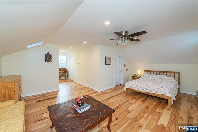 bedroom featuring lofted ceiling, light wood finished floors, baseboards, and recessed lighting