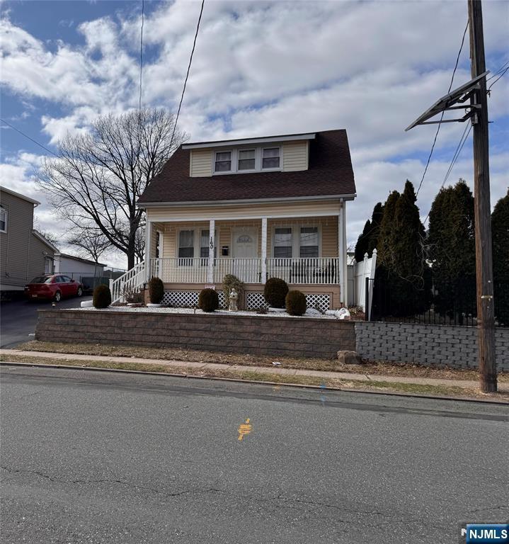 bungalow with a porch and a shingled roof