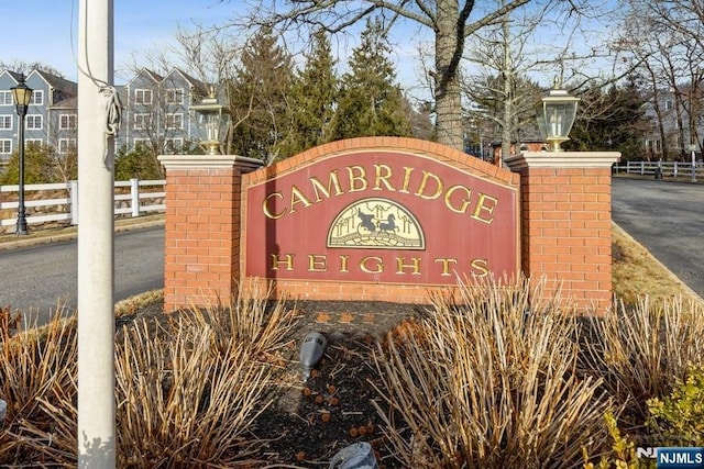 community sign featuring fence