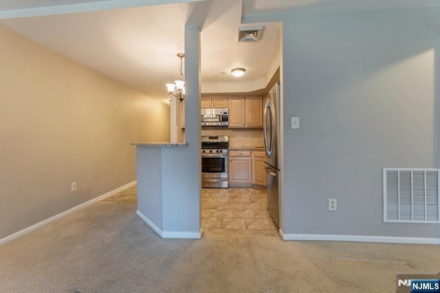 kitchen featuring a chandelier, visible vents, appliances with stainless steel finishes, and light carpet