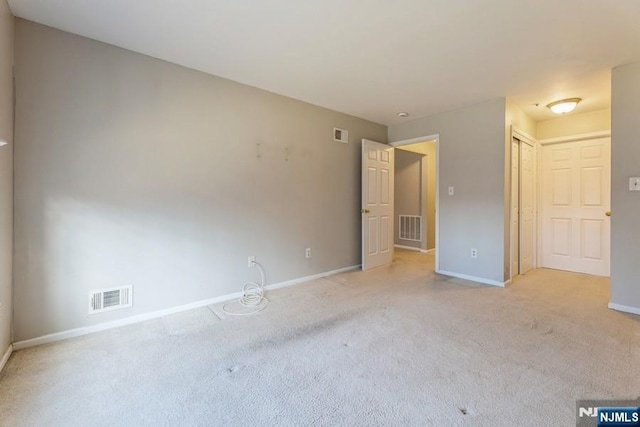 unfurnished bedroom featuring visible vents, baseboards, and carpet flooring