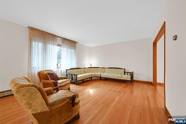 living area featuring light wood-type flooring and baseboards