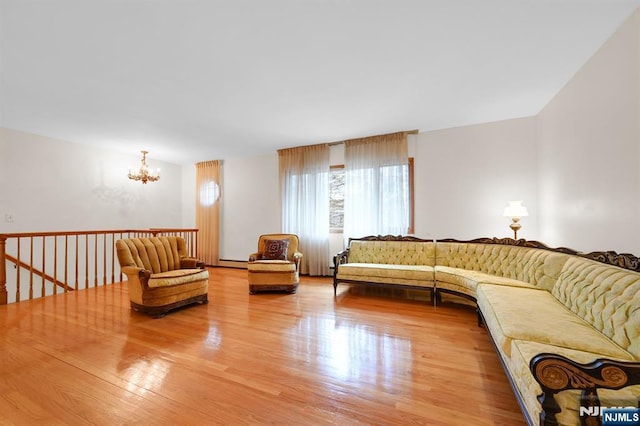 living room with light wood-type flooring and a chandelier