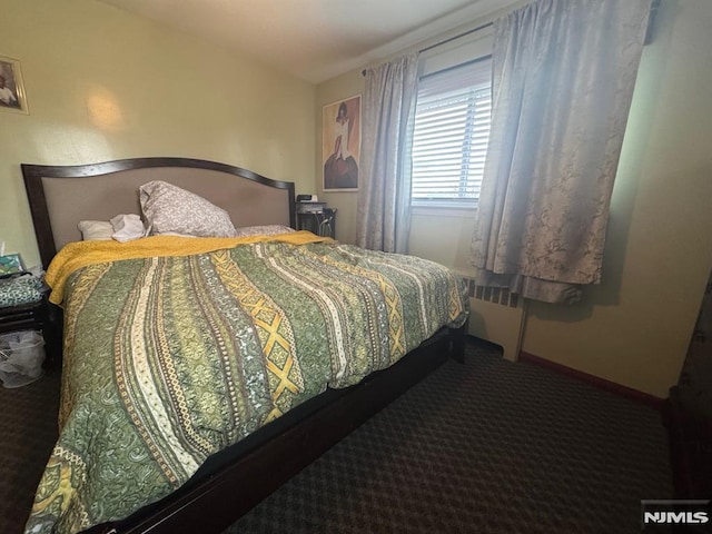 carpeted bedroom featuring baseboards