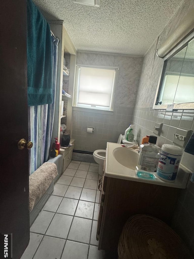 full bath featuring shower / tub combo with curtain, tile walls, a textured ceiling, and tile patterned floors