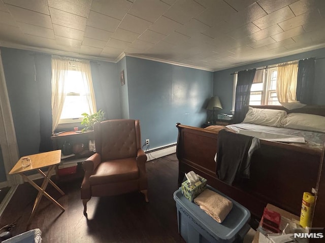 bedroom with a baseboard heating unit and crown molding