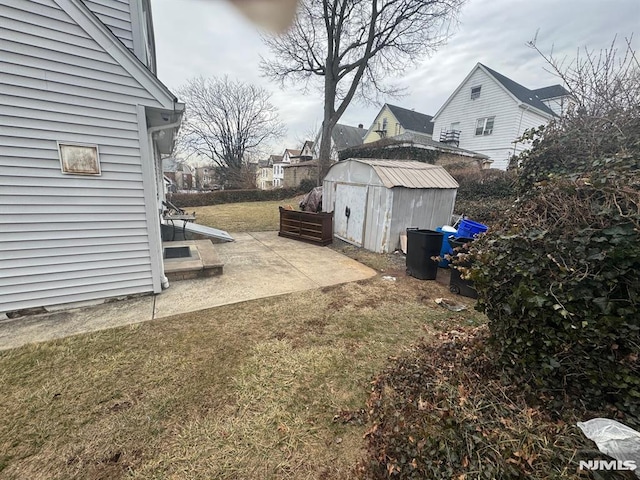 view of yard with a shed and an outbuilding