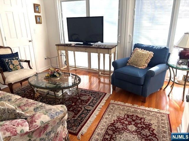 living area with wood finished floors and baseboards