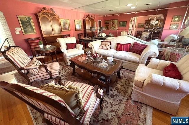 living room featuring a notable chandelier and wood finished floors