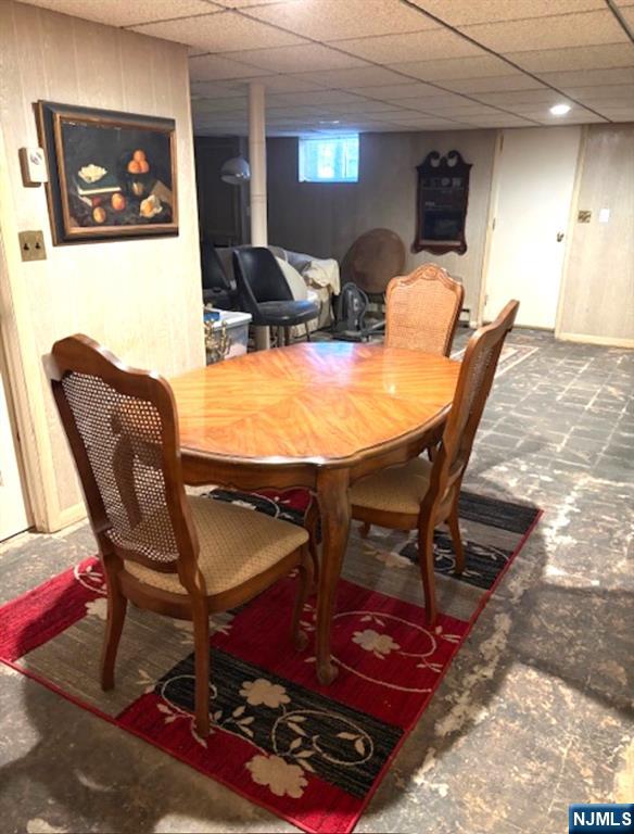 dining area featuring a paneled ceiling