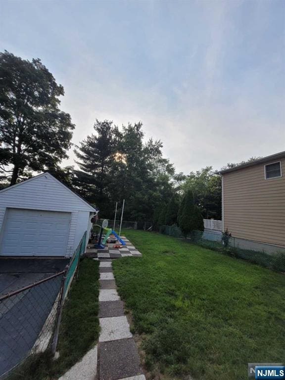 view of yard with an outbuilding and a garage