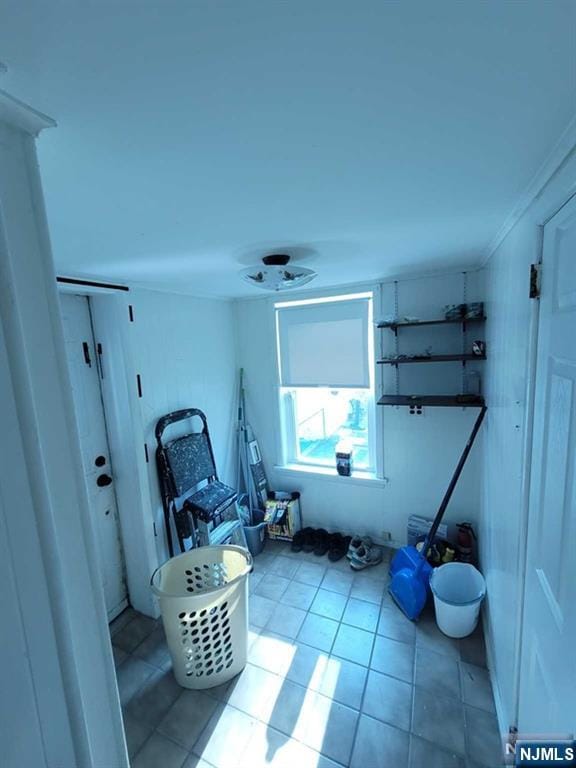 clothes washing area featuring tile patterned flooring