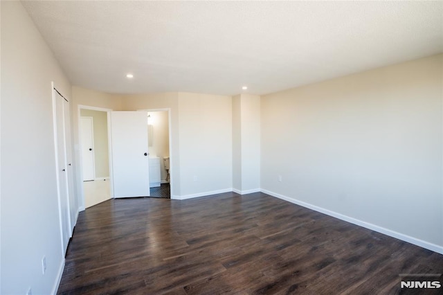 empty room with recessed lighting, baseboards, and dark wood-type flooring