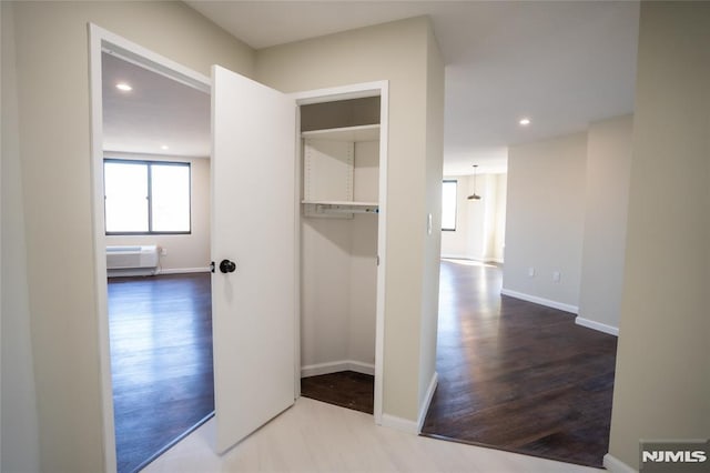 hallway with recessed lighting, baseboards, plenty of natural light, and wood finished floors