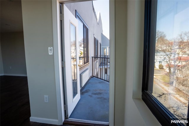 doorway featuring baseboards